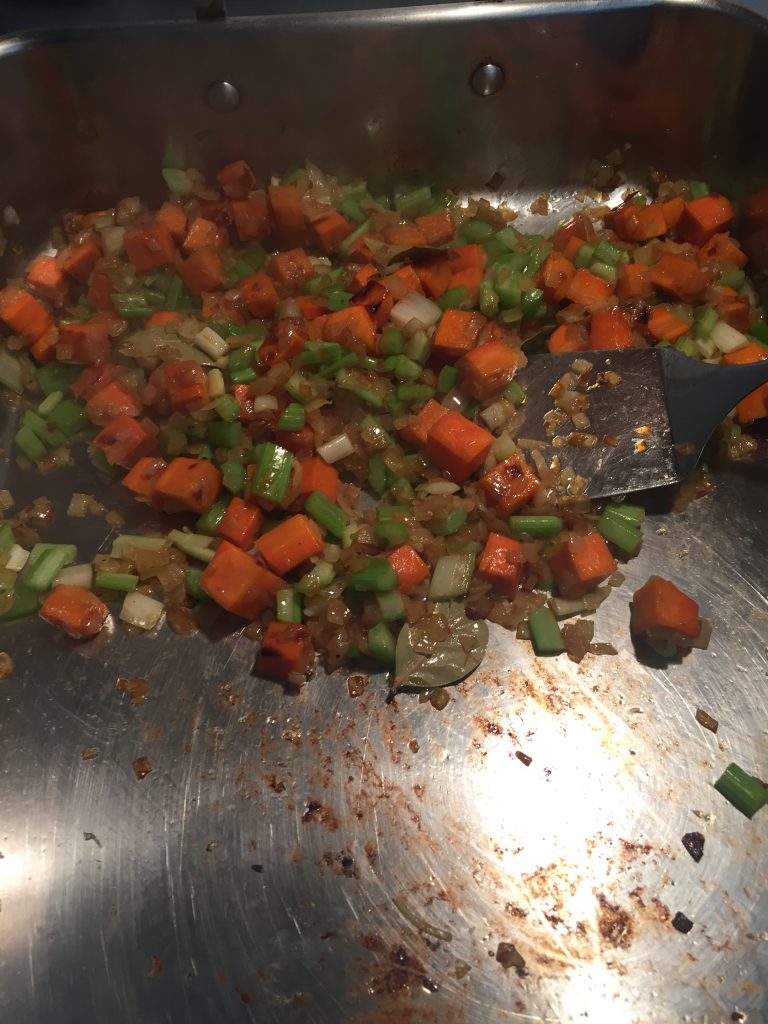 Onions, carrots and celery for mirepoix in braising pan. 