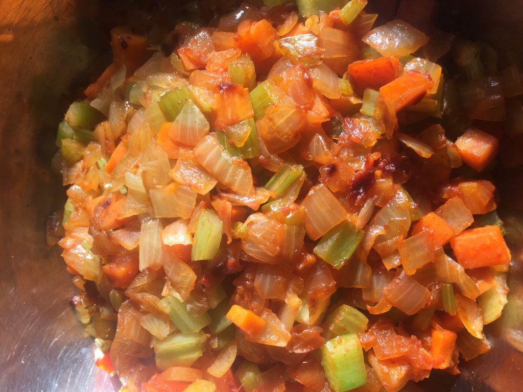 Onions, carrots and celery for mirepoix in braising pan. 