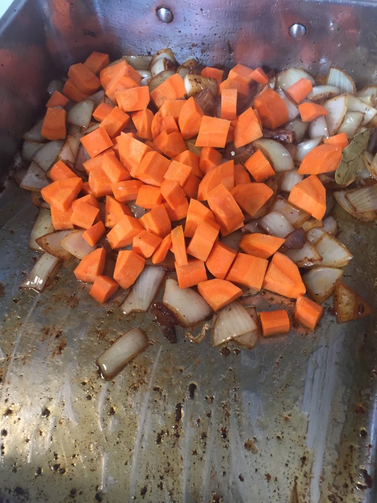 Onions and carrots for mirepoix in braising pan. 